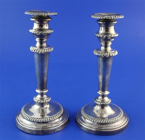 A pair of George III silver candlesticks, weighted.